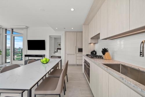 a kitchen with a counter and a table with chairs at Level Chicago - Fulton Market in Chicago