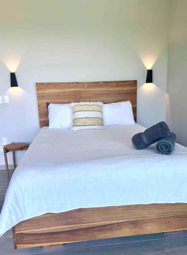 a bedroom with a large white bed with two pillows at Cielo Rojo in Savegre