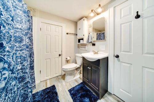 a bathroom with a white toilet and a sink at Meadville Apartment with Deck Less Than 2 Mi to Allegheny! in Meadville