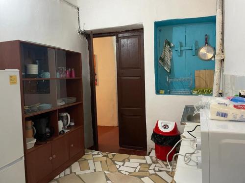 a kitchen with a door open to a kitchen with a floor at SAFARI in Stone Town