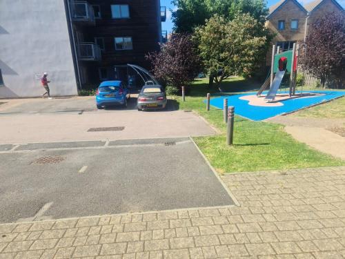 a parking lot with a playground with a slide at D Merciful Homes in Kent