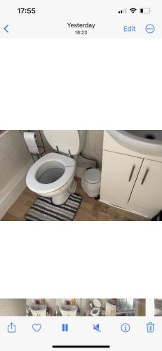 a bathroom with a white toilet in a room at Iphy’s address in Wolverhampton