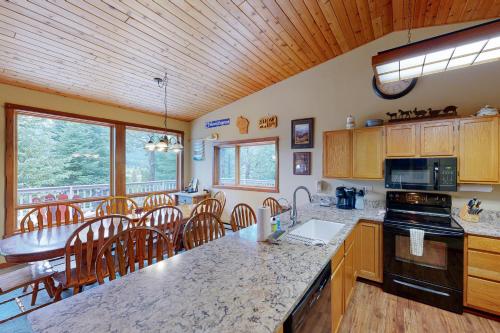a kitchen with a counter top and a dining room at Hidden Village 20 in Big Sky