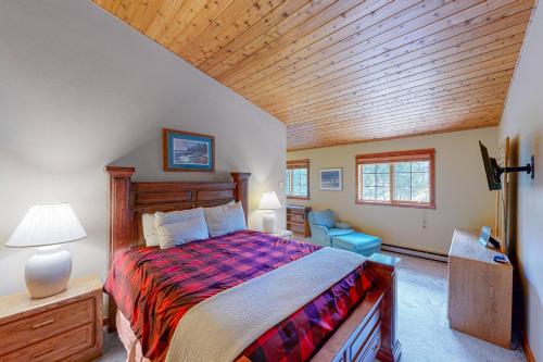 a bedroom with a bed and a wooden ceiling at Hidden Village 20 in Big Sky