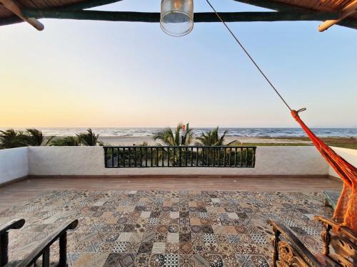 a view of the ocean from the balcony of a house at CHEVERE BEACH CABAÑAS SAS in Puebloviejo