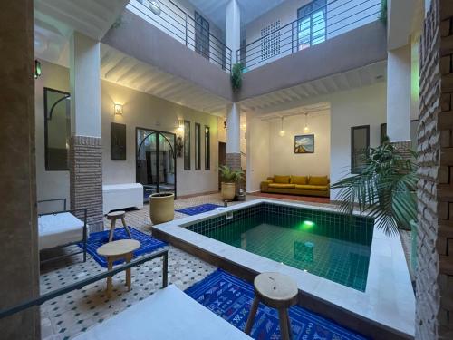 a swimming pool in the middle of a house at Riad Samarine in Marrakesh