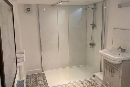 a bathroom with a shower and a sink at Bridgefoot Cottage in Froggatt