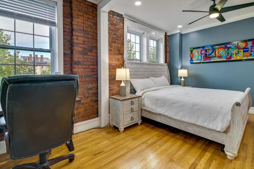 um quarto com uma cama e uma parede de tijolos em Contemporary Cohoes Retreat with Electric Fireplace! em Cohoes