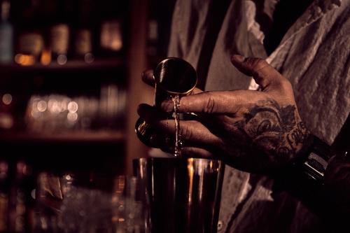 a man with a tattoo is holding a wine glass at Lily Hall-A Boutique Hotel in Pensacola