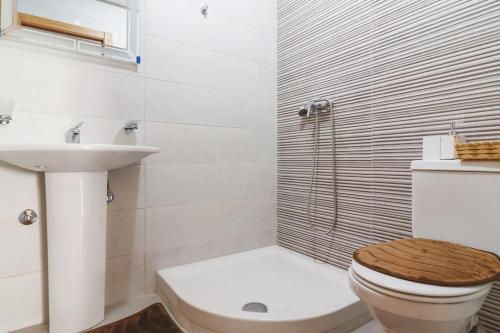 a white bathroom with a toilet and a sink at Magnifique Appartement Golf Tanger for Families in Tangier