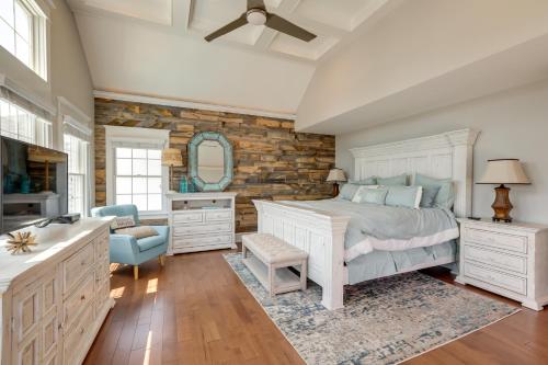 a bedroom with a bed and a stone wall at Waterfront Ocean City Escape with Large Deck, Pool! in Ocean City