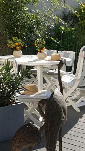 une table blanche avec des chaises et une table avec de la nourriture. dans l'établissement Chez Lily, à Vélizy-Villacoublay