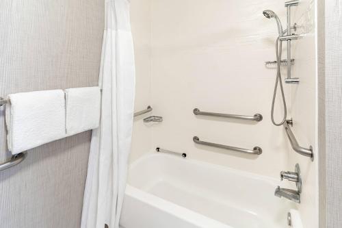 a bathroom with a shower and a bathtub with a shower curtain at Residence Inn Sacramento Rancho Cordova in Rancho Cordova