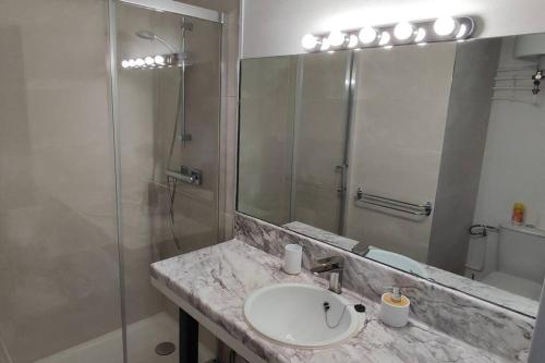 a bathroom with a sink and a shower at Saint Cyprien Sud Méditerranée. in Saint-Cyprien