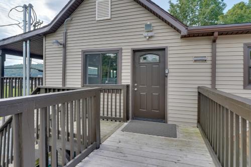 a home with a wooden porch with a brown door at Second-Floor Harveys Lake Apartment with Deck! in Harveys Lake