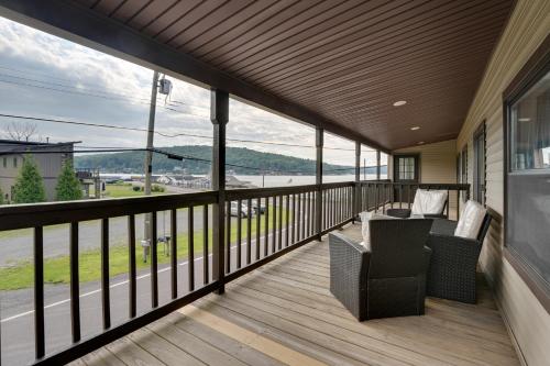 a screened porch with a view of the water at Second-Floor Harveys Lake Apartment with Deck! in Harveys Lake