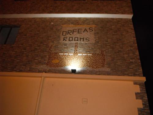 a sign on a brick wall with a ship on it at Orfeas Rooms in Vasiliki