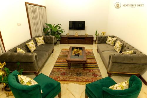 a living room with couches and a coffee table at Mother’s Nest Villa with Pool in Galle