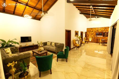a living room with couches and chairs and a television at Mother’s Nest Villa with Pool in Galle