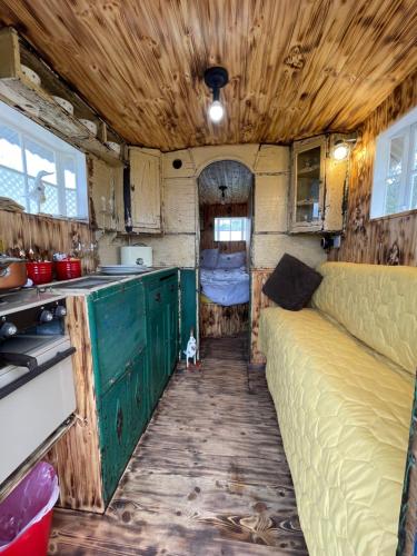 an interior of an rv with a couch and a kitchen at Ty Gwenyn, Coity Bach in Brecon