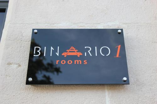 a sign on the side of a building at Binario1 Rooms in Barletta