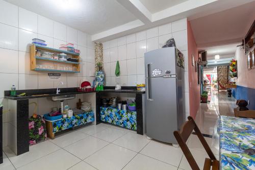 a kitchen with a stainless steel refrigerator and a counter at Magia D'ajuda Hospedagem in Arraial d'Ajuda