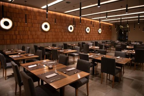 a dining room with wooden tables and chairs at Hotel Alejandro I - Affiliated by Meliá in Salta