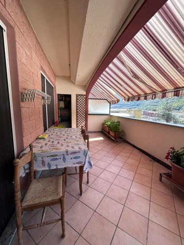 a table and chairs in a room with a window at Otto Marzo in Finale Ligure