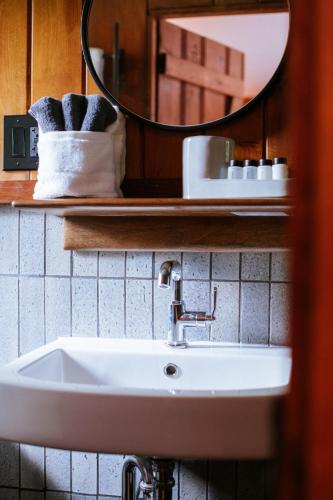 a bathroom with a sink and a mirror and towels at The Leeway in Mount Tremper