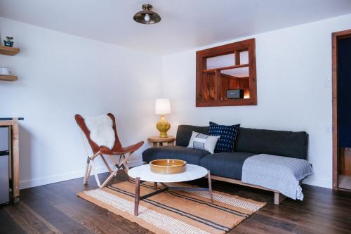 a living room with a couch and a table at The Leeway in Mount Tremper