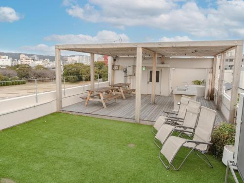 a patio with chairs and a table on a roof at Bond Building 3F - Vacation STAY 45724v in Wakayama