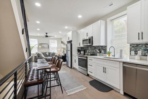 a kitchen with white cabinets and a table and chairs at Modern City living in Philadelphia