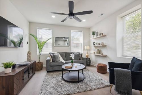 a living room with a couch and a ceiling fan at Modern City living in Philadelphia