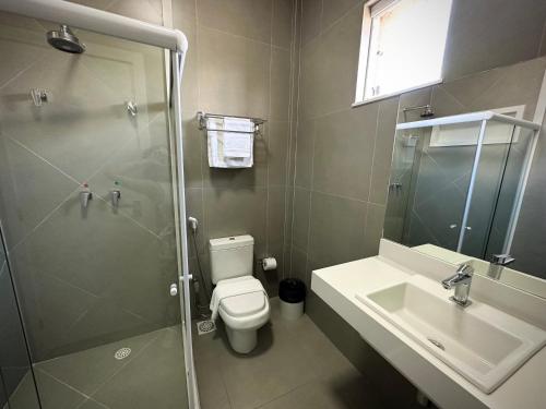 a bathroom with a shower and a toilet and a sink at DM HOTEL in Propriá