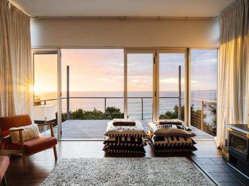 a living room with a view of the ocean at Holland House Bay of Fires in Binalong Bay