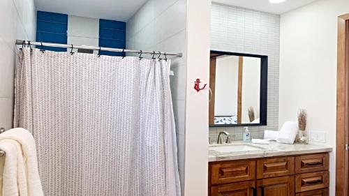 a bathroom with a shower curtain and a sink at Brand New Beautiful House La Brisas by Kivoya in Playa Encanto