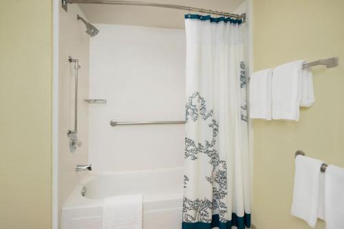 a bathroom with a shower curtain and a tub at Residence Inn Bakersfield in Bakersfield
