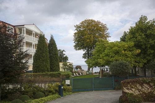 班辛海的住宿－Haus Rolandseck - FeWo 03，一座带栅栏和树木的大型白色房屋