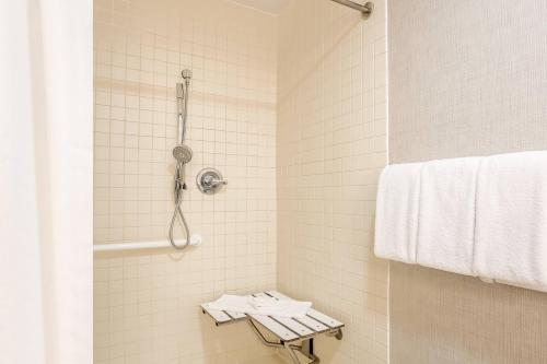 a bathroom with a shower with a towel at Residence Inn by Marriott Atlanta Cumberland/Galleria in Atlanta