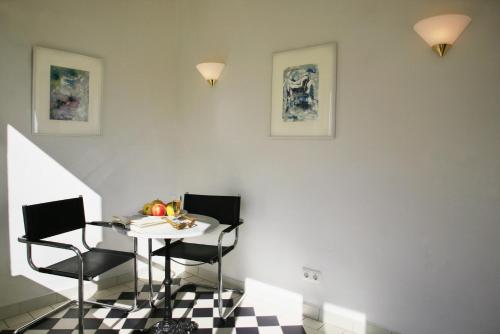 a dining room with a table and two chairs at Villa Daheim - FeWo 01 in Kolpinsee