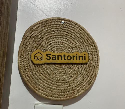 a santoni sign on a wicker hat on a wall at 93 Homes and Residence (Shortlet Apartment in Abuja) in Abuja