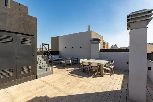 a balcony with a table and chairs on a roof at Live Soho Boutique & Apartments Palermo Hollywood in Buenos Aires