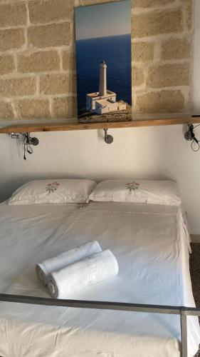a bed with two towels on top of it at A Casa di Lu in Minervino di Lecce