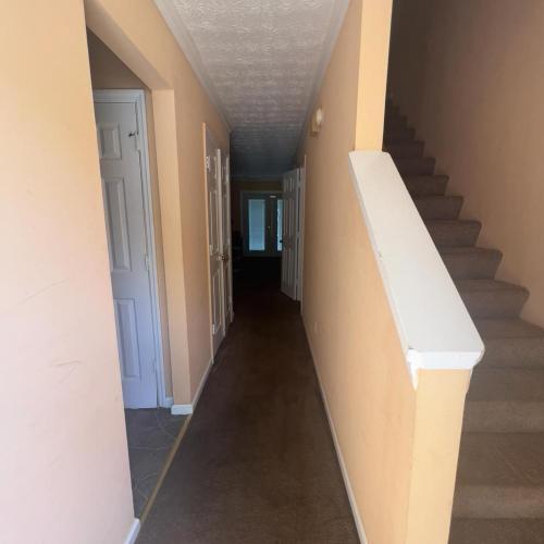 an empty hallway with stairs in a house at #Cozy2BR Near Stonecrest Stone MTN Park in Lithonia