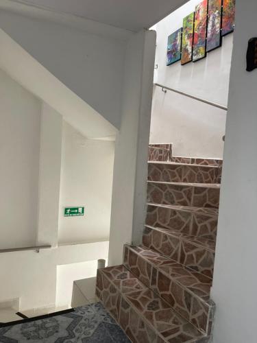 a staircase in a building with a brick wall at HospedajeLR in Barrancabermeja