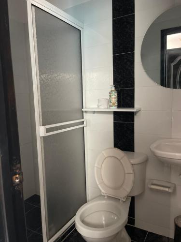 a bathroom with a shower and a toilet and a sink at HospedajeLR in Barrancabermeja