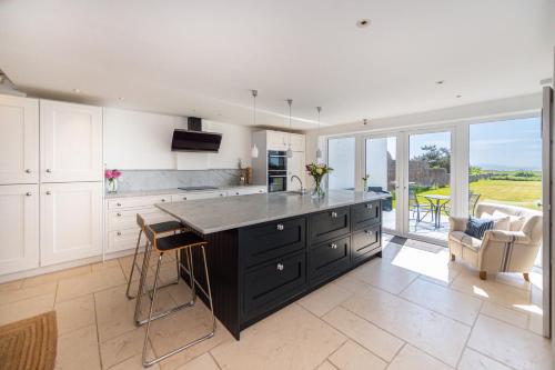 a kitchen with a large black island in the middle at Sea View Luxury Beach House in Crosby