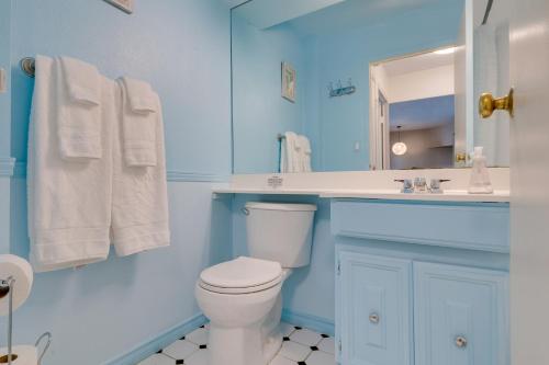 a blue bathroom with a toilet and a sink at Downtown Seattle Condo with Rooftop Deck and Views! in Seattle