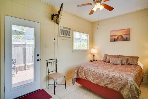 a bedroom with a bed and a ceiling fan at Lake Charles Vacation Rental with Private Patio! in Lake Charles