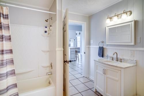 a bathroom with a tub and a sink and a shower at Lake Charles Vacation Rental - Walk to the Lake! in Lake Charles
